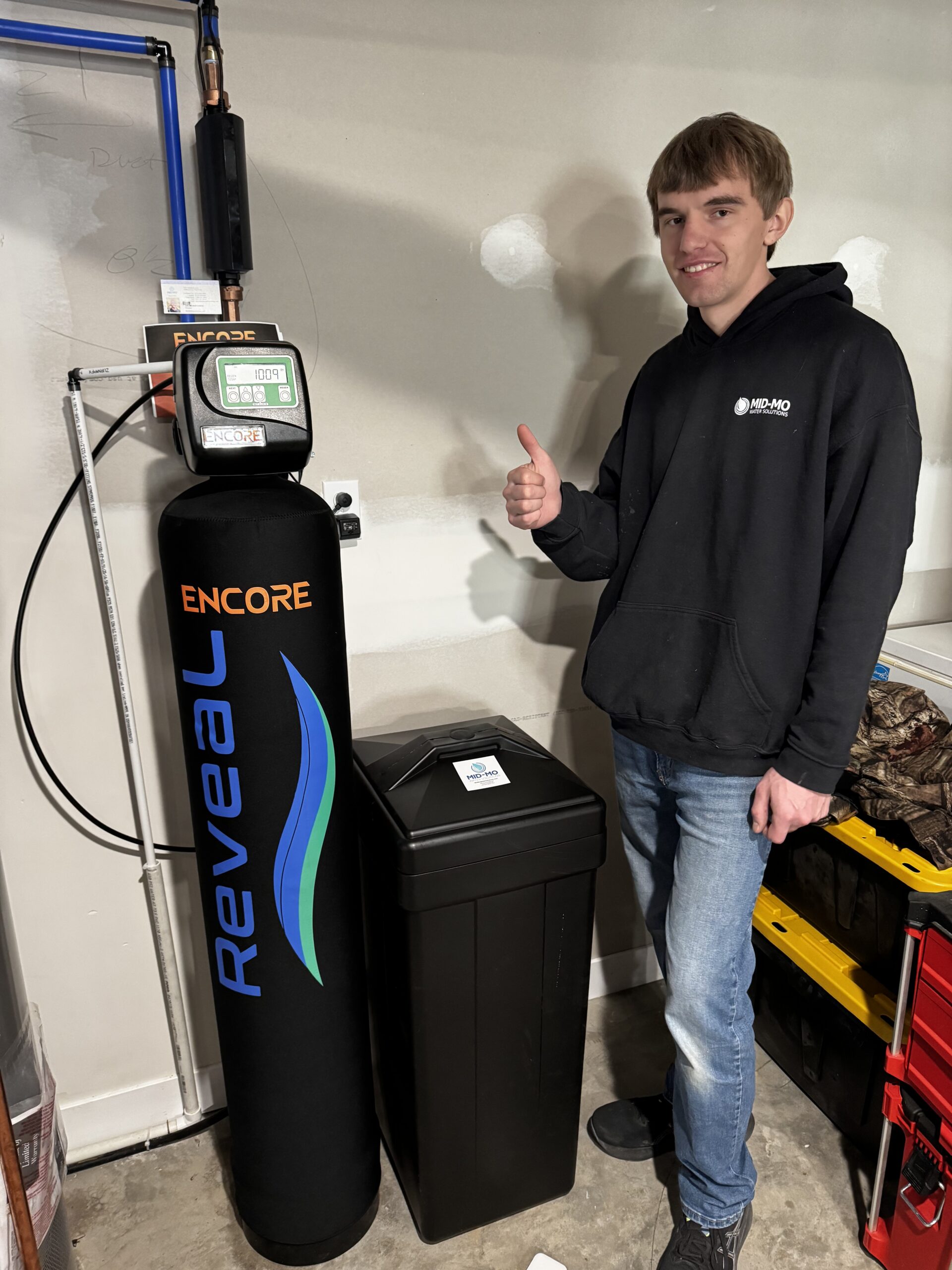 Employee posing with freshly installed water softener